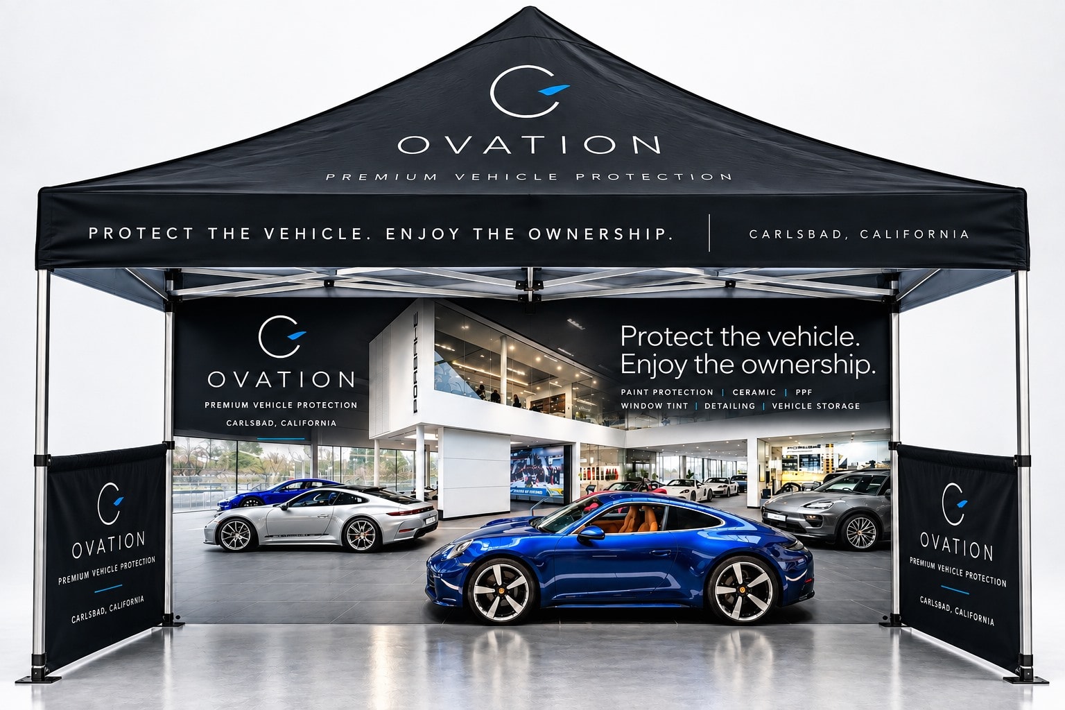 The Ovation pop-up stand, its canopy carrying the Ovation mark, with sports cars under and behind it.
