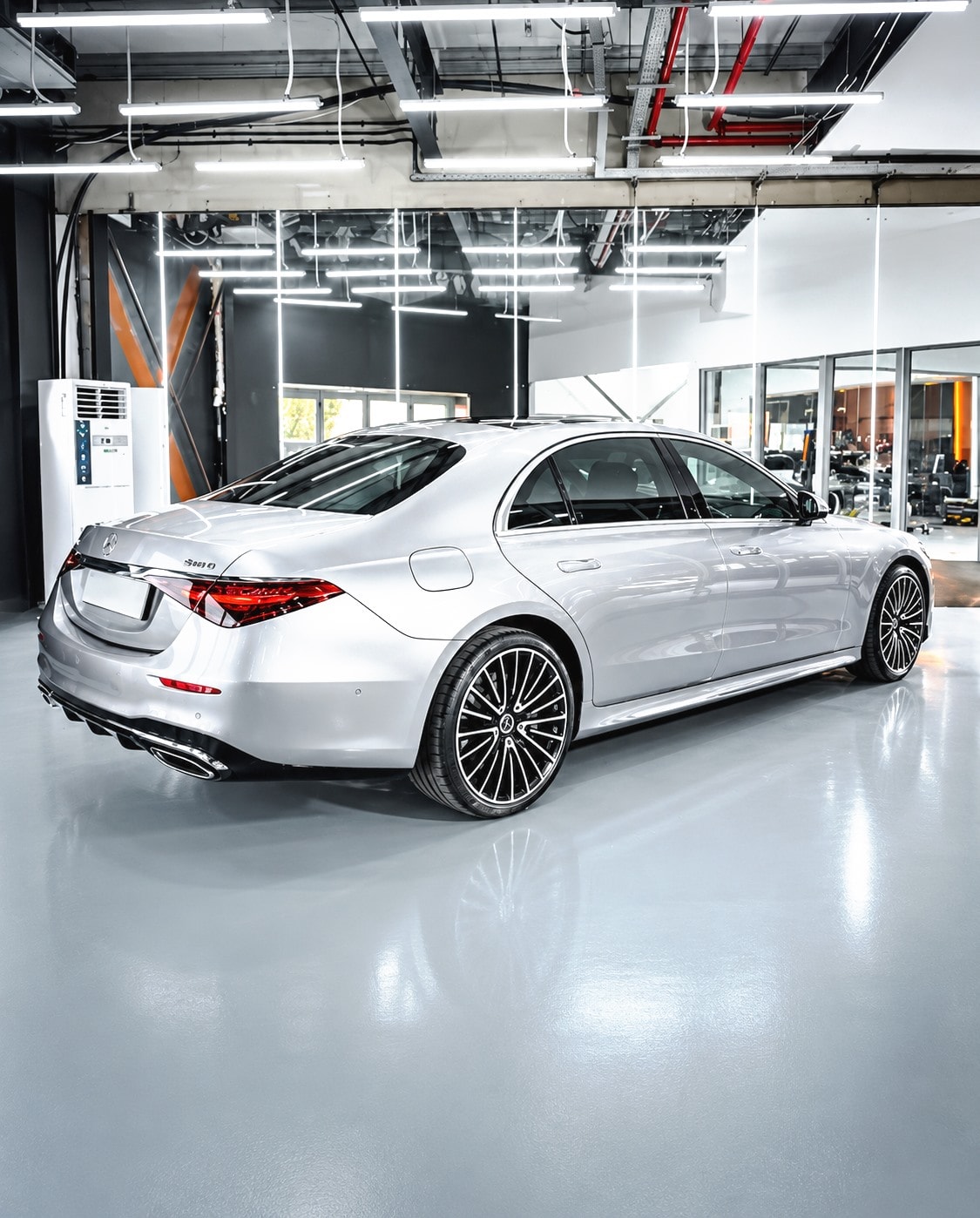 A silver Mercedes-Benz sedan in an installation bay.