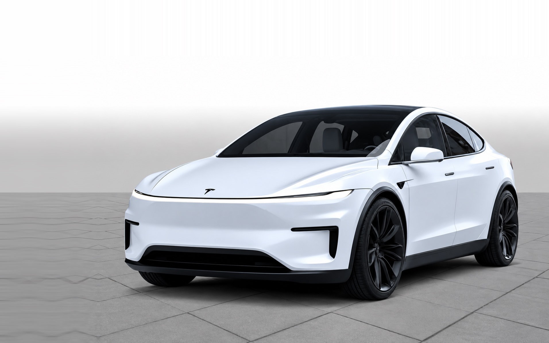 A white Tesla, photographed front three-quarter in a studio.
